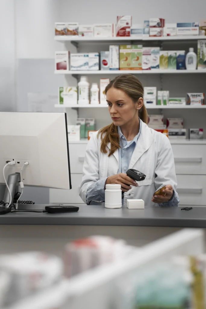 Female Pharmacist Scanning Medicine Counter